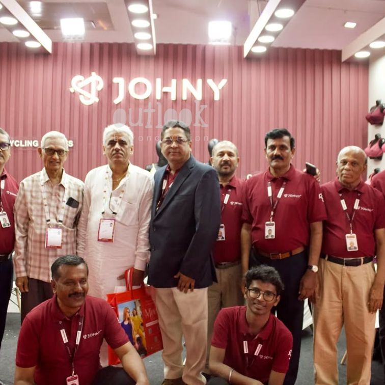 JOHNY team and industry guests at exhibition stall enjoying event