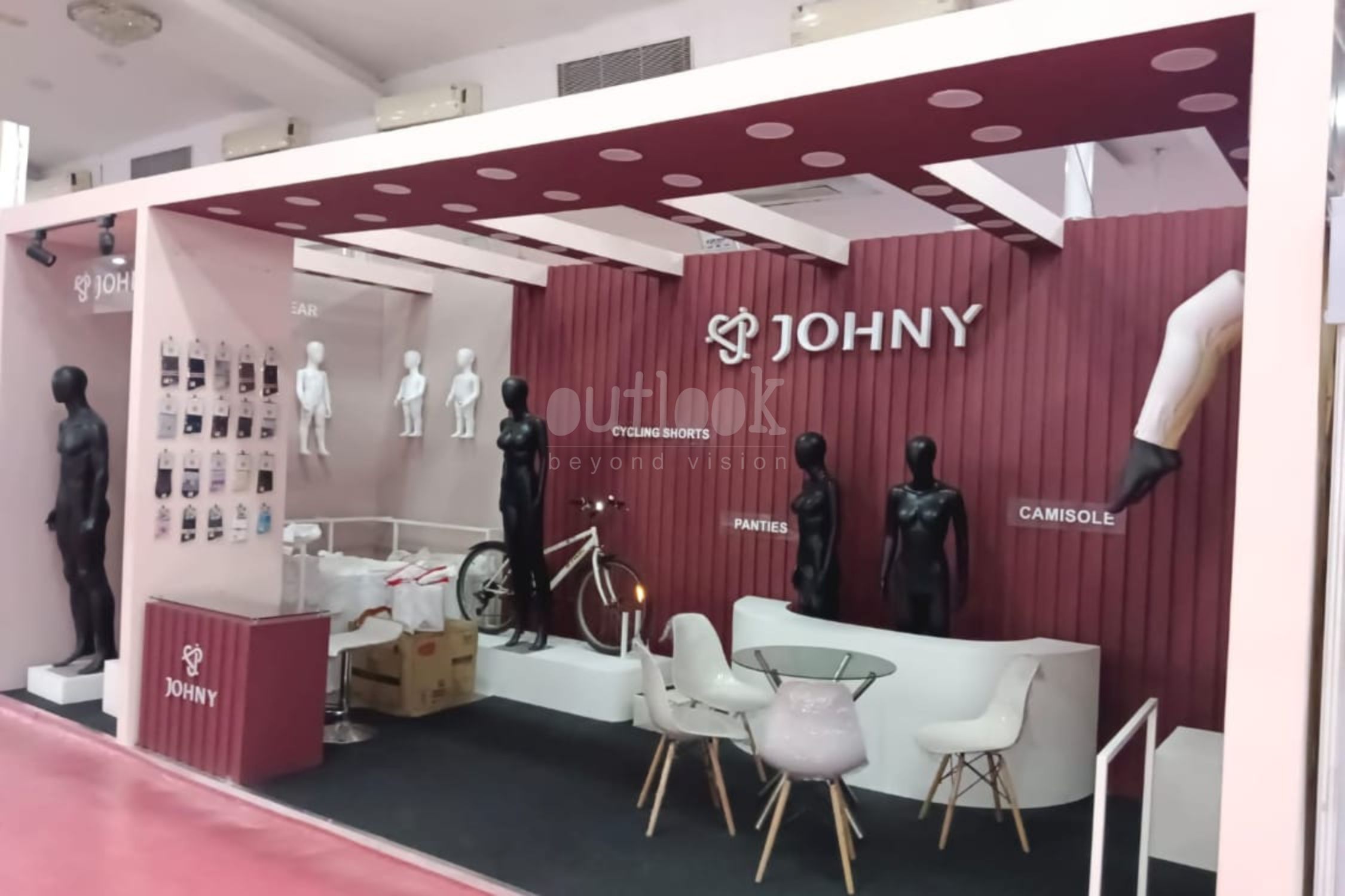 JOHNY exhibition stand with mannequins, product wall, and creative branded design at event in India