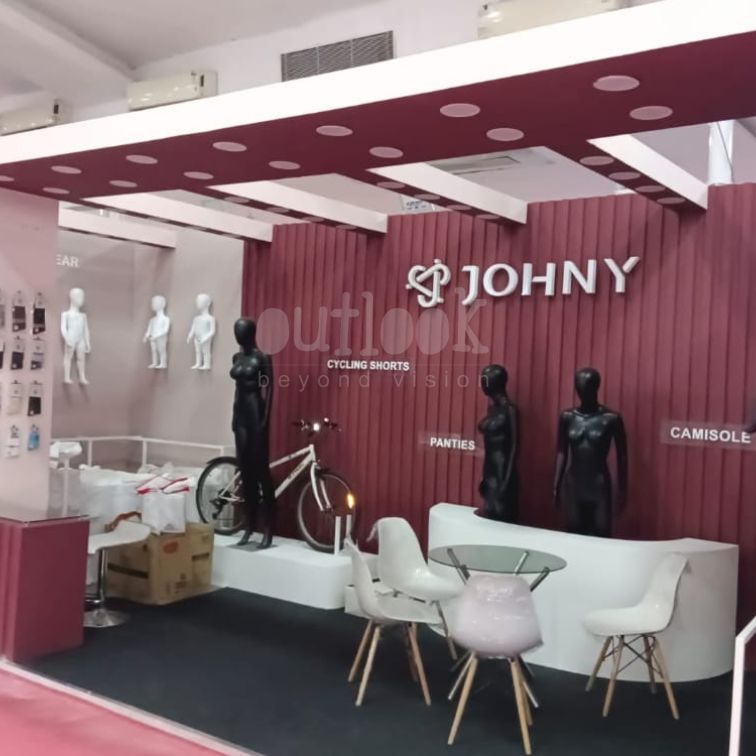JOHNY exhibition stall with cycling shorts, mannequins, and modern lounge setup
